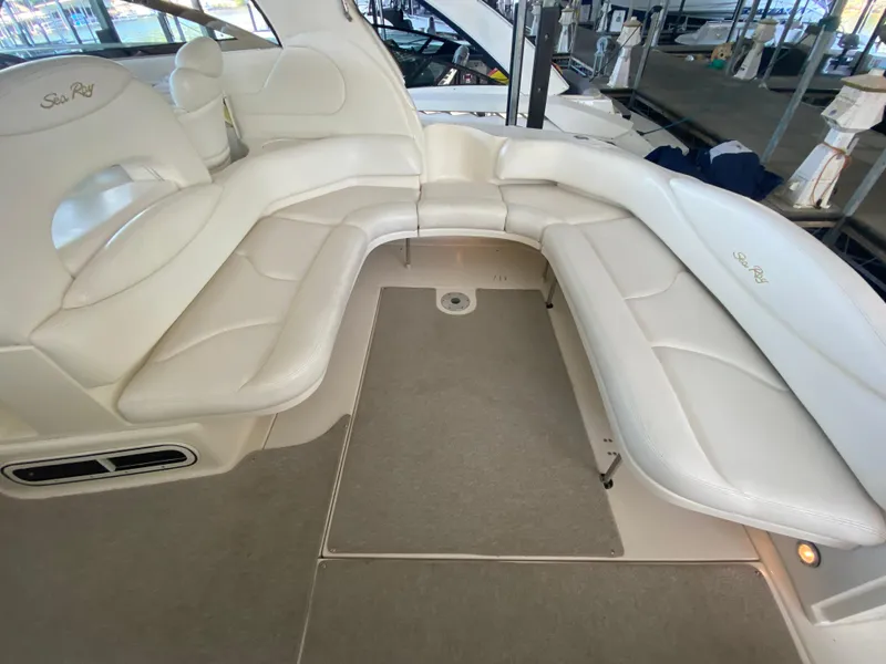 Slide: The Image of 1999 Sea Ray 380 Sundancer interior with white leather seating and carpeted floor. - 8
