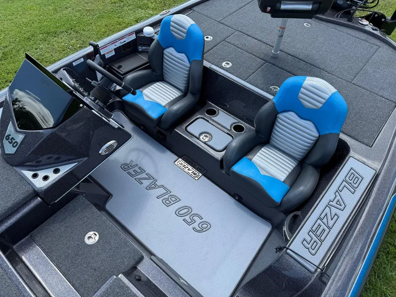 Slide: The Image of Blazer 650 NAP 2026 boat interior with blue and gray seats, modern dashboard. - 10