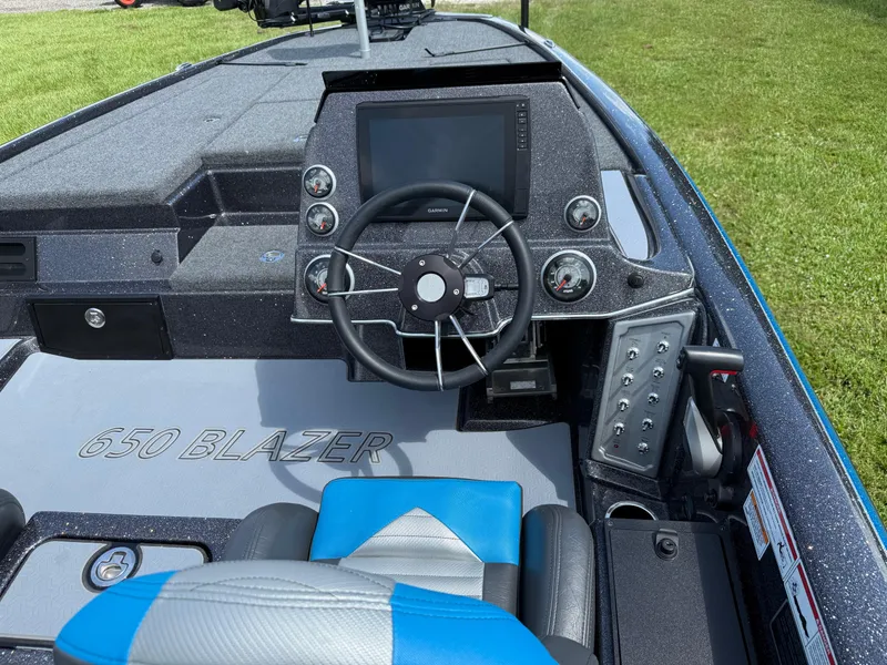 Slide: The Image of 2026 Blazer 650 NAP boat dashboard with steering wheel and control panel. - 13