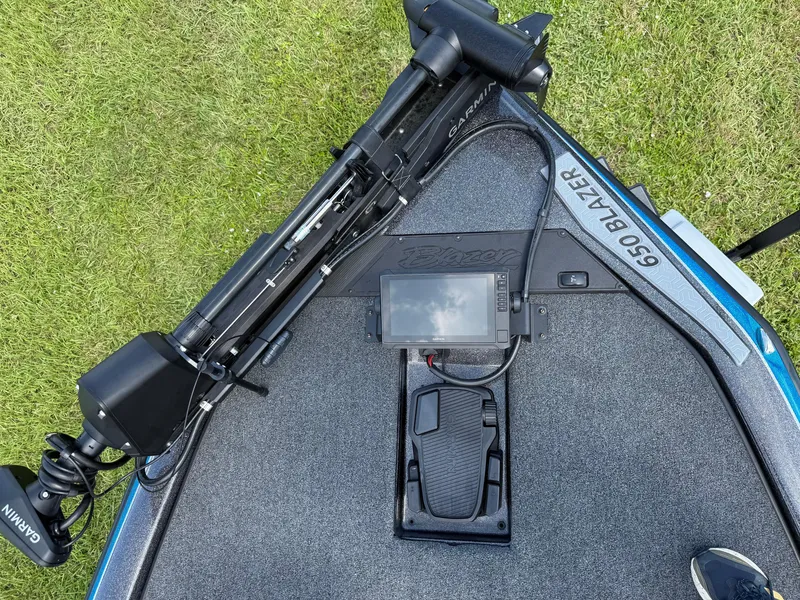 Slide: The Image of 2026 Blazer 650 NAP boat deck with Garmin equipment and foot pedal on grass. - 7