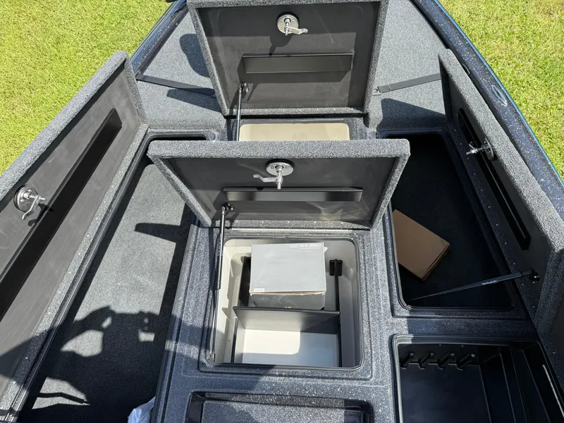 Slide: The Image of Open storage compartments in a 2026 Blazer 650 NAP boat, showcasing ample space and organization. - 8