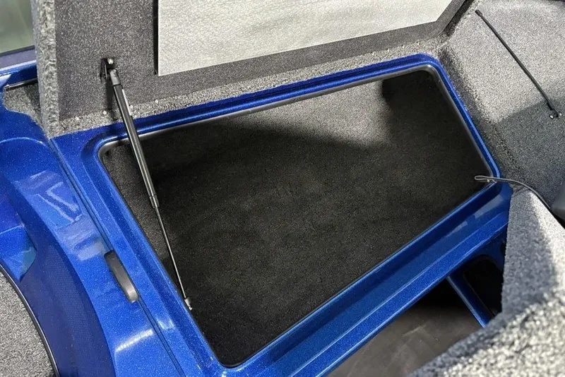 Slide: The Image of Open storage compartment in a 2026 Nitro Z17 boat, featuring a blue interior. - 21