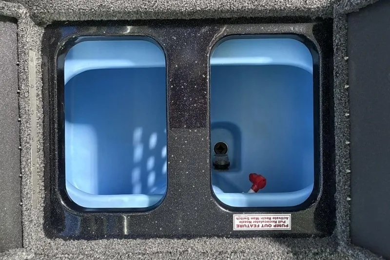 Slide: The Image of Interior compartments of a 2026 Nitro Z17 boat, featuring dual blue storage areas. - 27