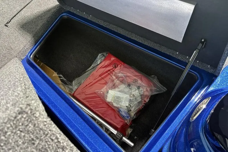 Slide: The Image of Storage compartment of a 2026 Nitro Z17 boat, containing a red bag and accessories. - 7