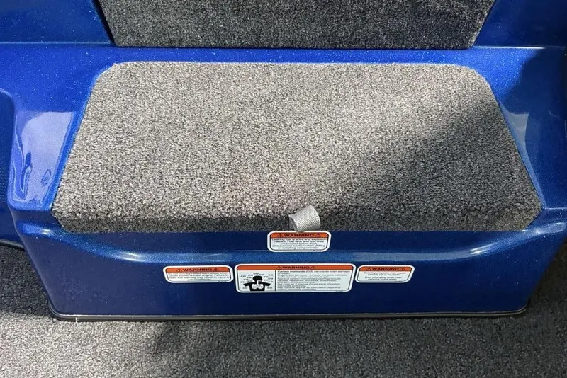 Slide: The Image of Blue Nitro Z17 boat step with gray carpet, warning labels, 2026 model. - 8
