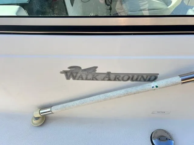 Slide: The Image of 2002 Wellcraft 24 Walkaround boat with cleaning brush on deck. - 5