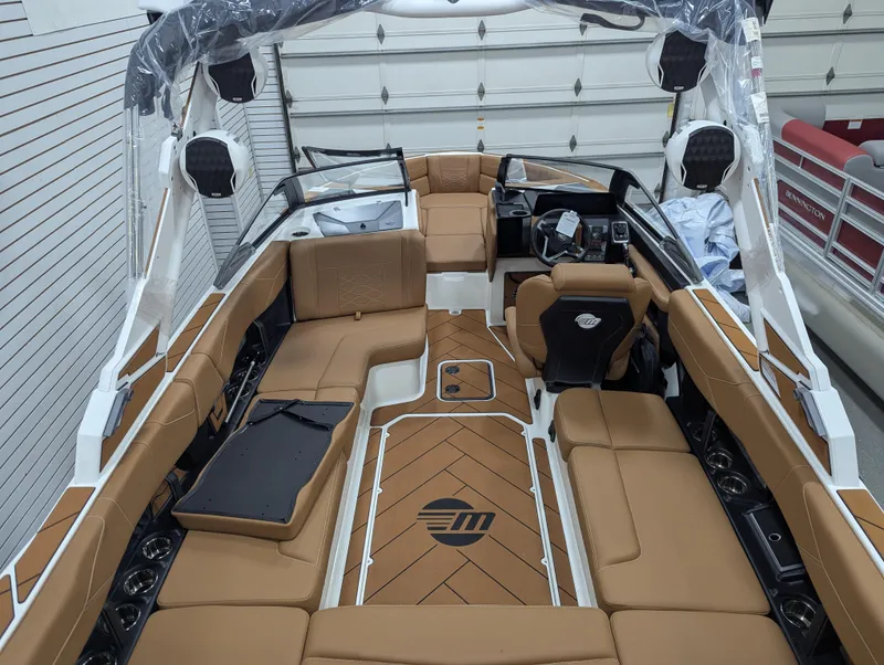 Slide: The Image of 2026 Malibu 23 LSV boat interior with tan seating and modern design. - 11