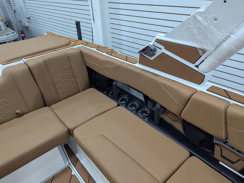 Slide: The Image of 2026 Malibu 23 LSV boat interior with tan seating and modern design. - 12