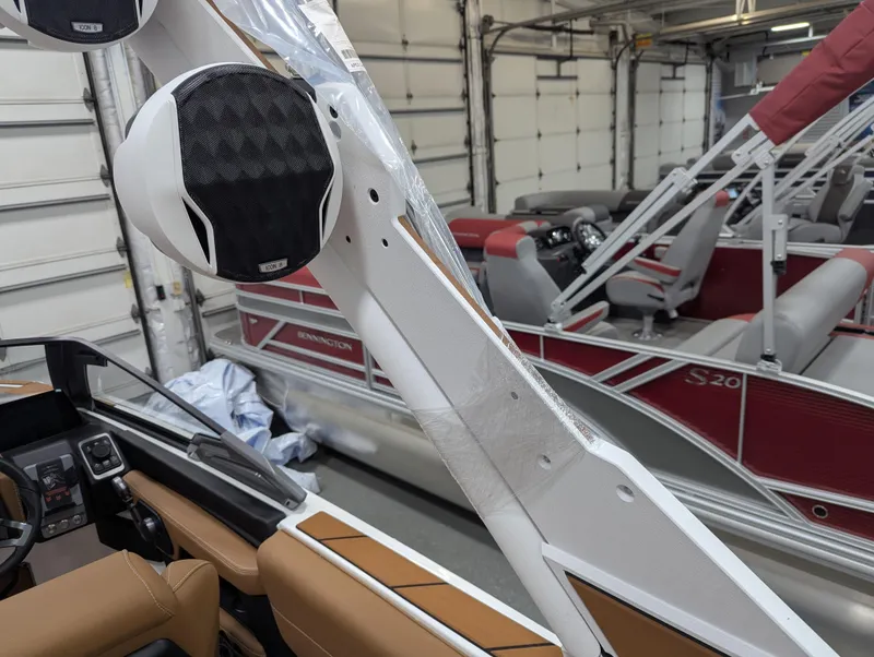 Slide: The Image of 2026 Malibu 23 LSV boat interior with tan leather seating and cup holders. - 15