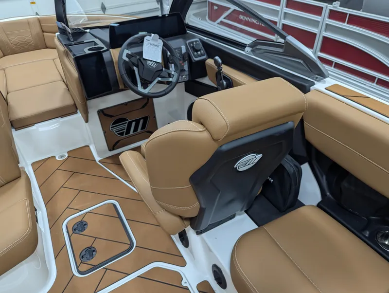 Slide: The Image of 2026 Malibu 23 LSV boat interior with speakers and luxury seating in a showroom. - 16