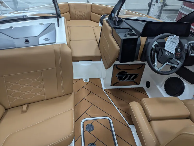 Slide: The Image of 2026 Malibu 23 LSV boat interior with tan seating and modern dashboard. - 17