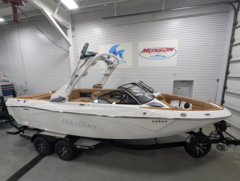 Slide: The Image of 2026 Malibu Wakesetter 23 LSV boat displayed indoors on a trailer. - 2