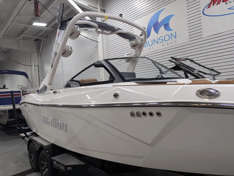 Slide: The Image of 2026 Malibu 23 LSV boat in showroom, featuring sleek white design and modern features. - 5