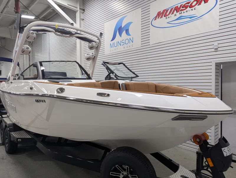 Slide: The Image of 2026 Malibu 23 LSV boat in showroom, featuring sleek design and modern wakeboard tower. - 6