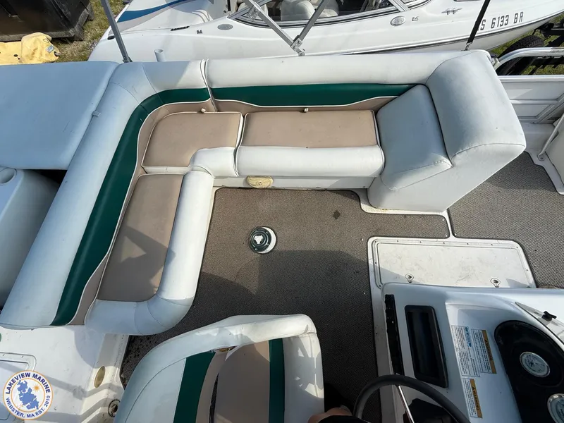 Slide: The Image of 2005 Hurricane FunDeck 226 REF boat interior with cushioned seating and steering console. - 11
