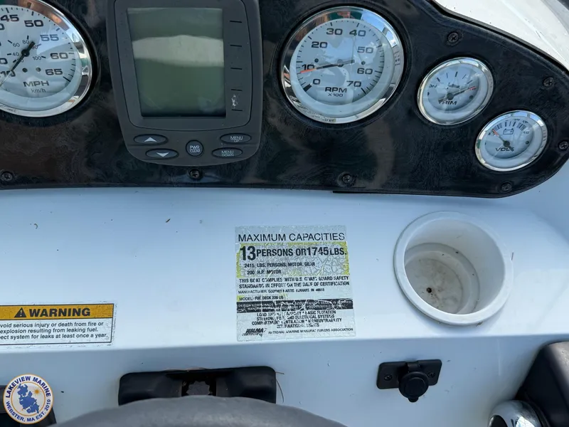 Slide: The Image of Dashboard of 2005 Hurricane FunDeck 226 REF with gauges and capacity warning label. - 13