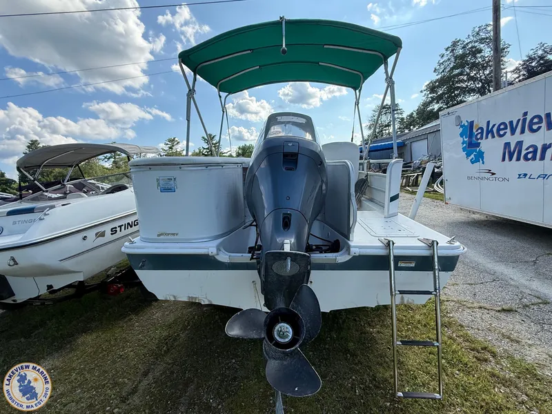 Slide: The Image of 2005 Hurricane FunDeck 226 REF boat with outboard motor and green canopy at Lakeview Marine. - 2