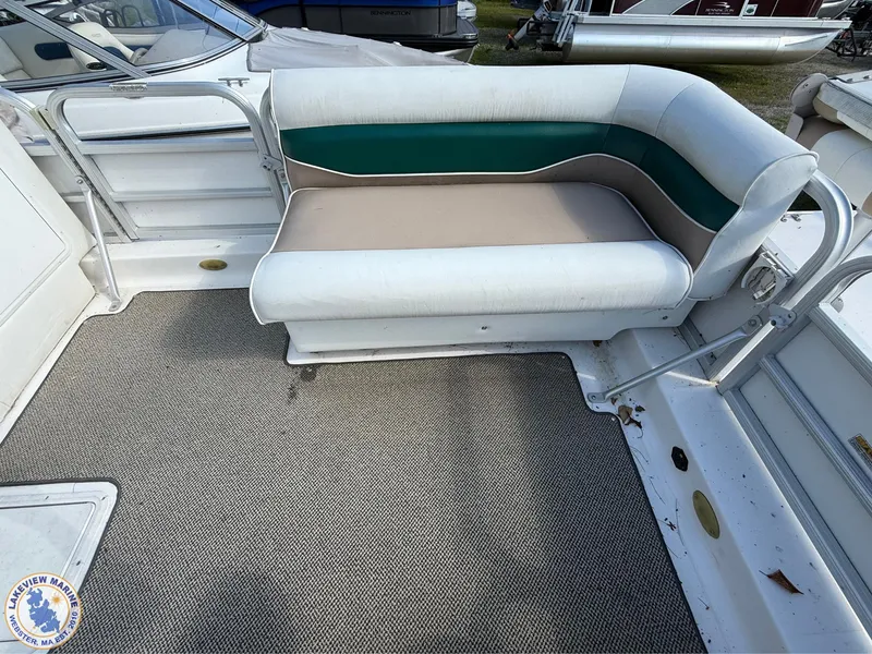 Slide: The Image of 2005 Hurricane FunDeck 226 REF boat interior with cushioned seating and carpeted floor. - 6