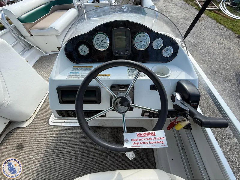 Slide: The Image of 2005 Hurricane FunDeck 226 REF boat dashboard with steering wheel and gauges. - 7