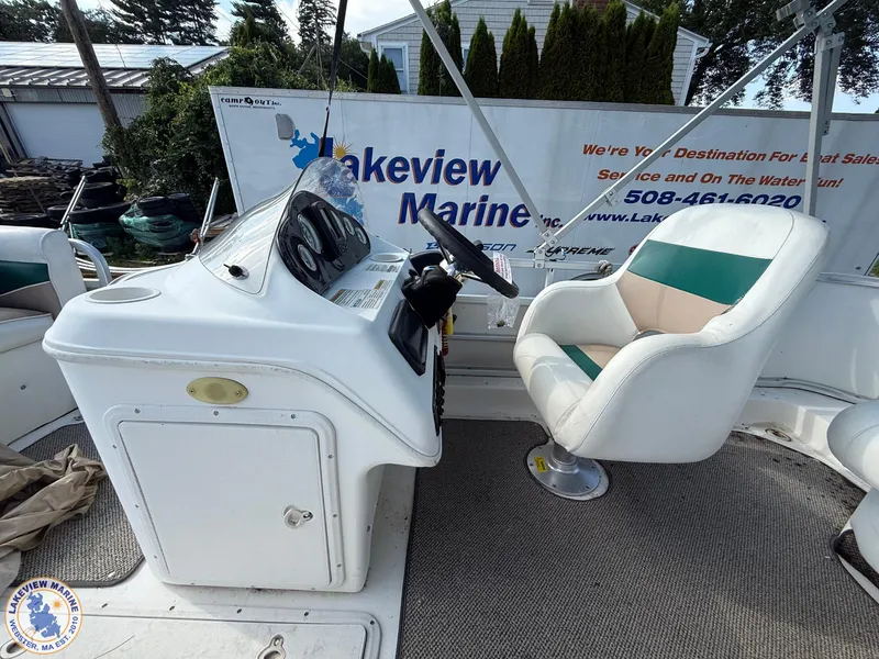 Slide: The Image of 2005 Hurricane FunDeck 226 REF boat interior with captain's chair and control panel. - 8
