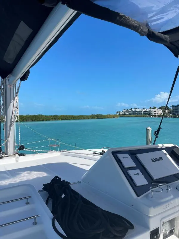 Slide: The Image of Lagoon 450 F catamaran, 2018 model, sailing in turquoise waters with clear blue sky. - 10