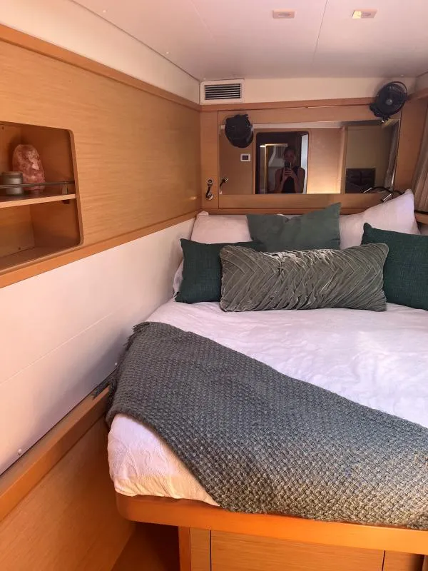 Slide: The Image of Luxurious cabin interior of 2018 Lagoon 450 F catamaran with cozy bedding and wooden accents. - 3