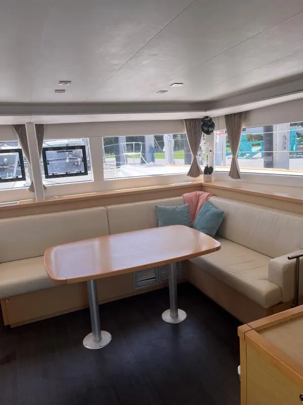Slide: The Image of Interior of 2018 Lagoon 450 F catamaran with cozy seating and dining area. - 4