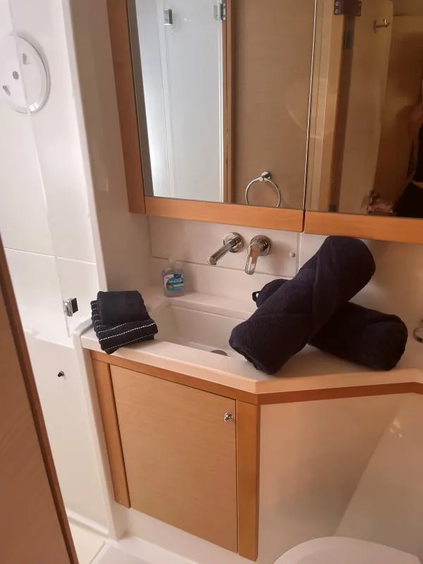 Slide: The Image of Bathroom interior of 2018 Lagoon 450 F yacht with towels and sink. - 7