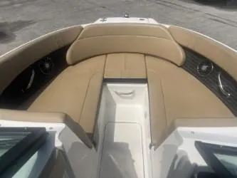Slide: The Image of 2024 Sea Ray SPX 230 boat interior with tan seating and sleek design. - 10