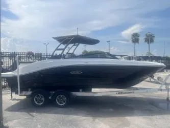 Slide: The Image of 2024 Sea Ray SPX 230 boat on trailer under a cloudy sky. - 2