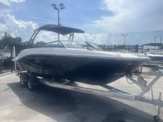 Slide: The Image of 2024 Sea Ray SPX 230 boat on trailer under a cloudy sky. - 3