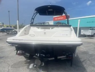 Slide: The Image of 2024 Sea Ray SPX 230 boat, rear view, parked outdoors. - 5