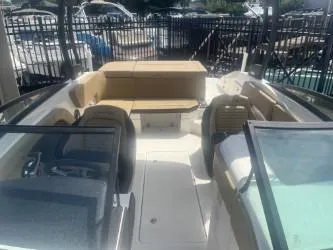 Slide: The Image of 2024 Sea Ray SPX 230 boat interior with seating and steering wheel. - 6