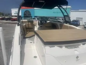 Slide: The Image of 2024 Sea Ray SPX 230 boat with beige seating and sleek design. - 7