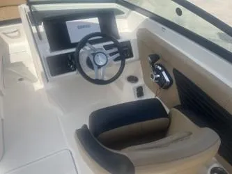Slide: The Image of 2024 Sea Ray SPX 230 boat interior with steering wheel and dashboard. - 9