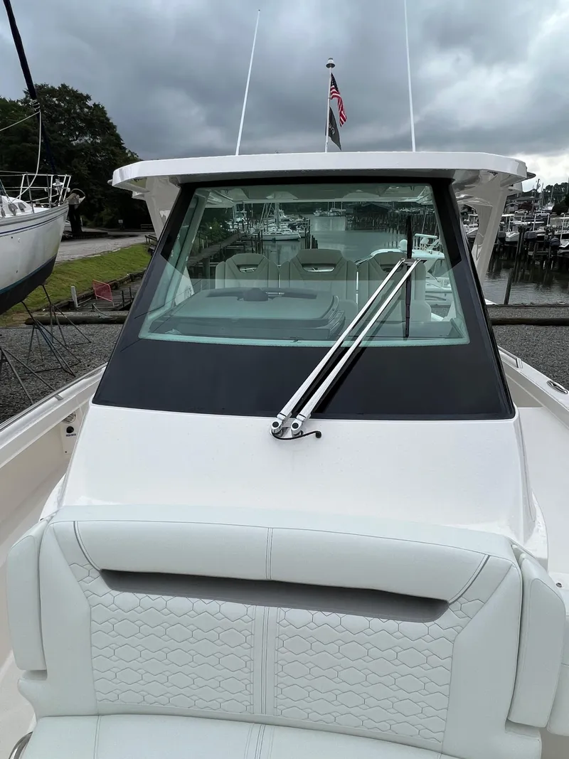 Slide: The Image of 2026 Tiara Yachts 34 LS with sleek design, docked under cloudy skies. - 11