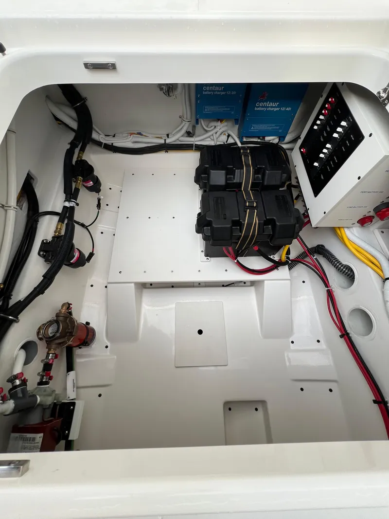 Slide: The Image of Engine compartment of 2026 Tiara Yachts 34 LS, featuring batteries and electrical components. - 18