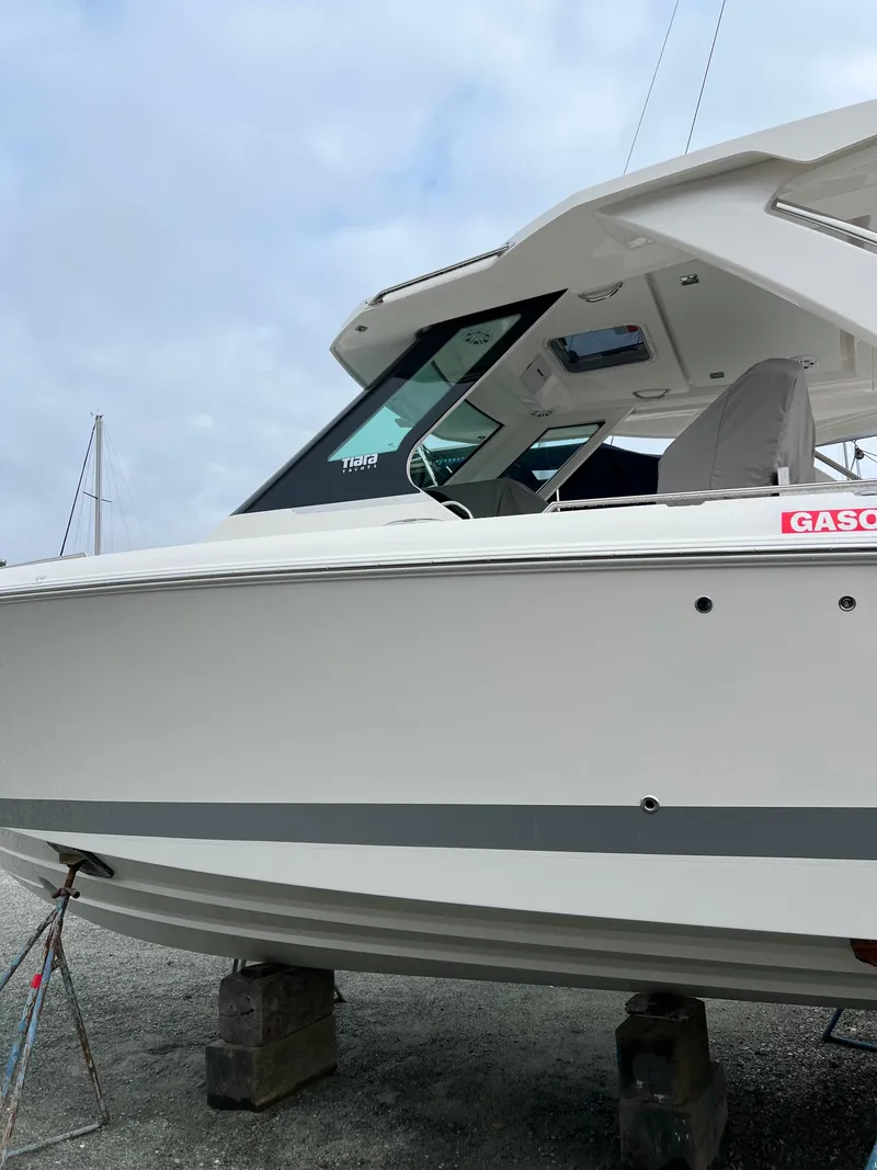 Slide: The Image of 2026 Tiara Yachts 34 LS on blocks, side view with overcast sky. - 19