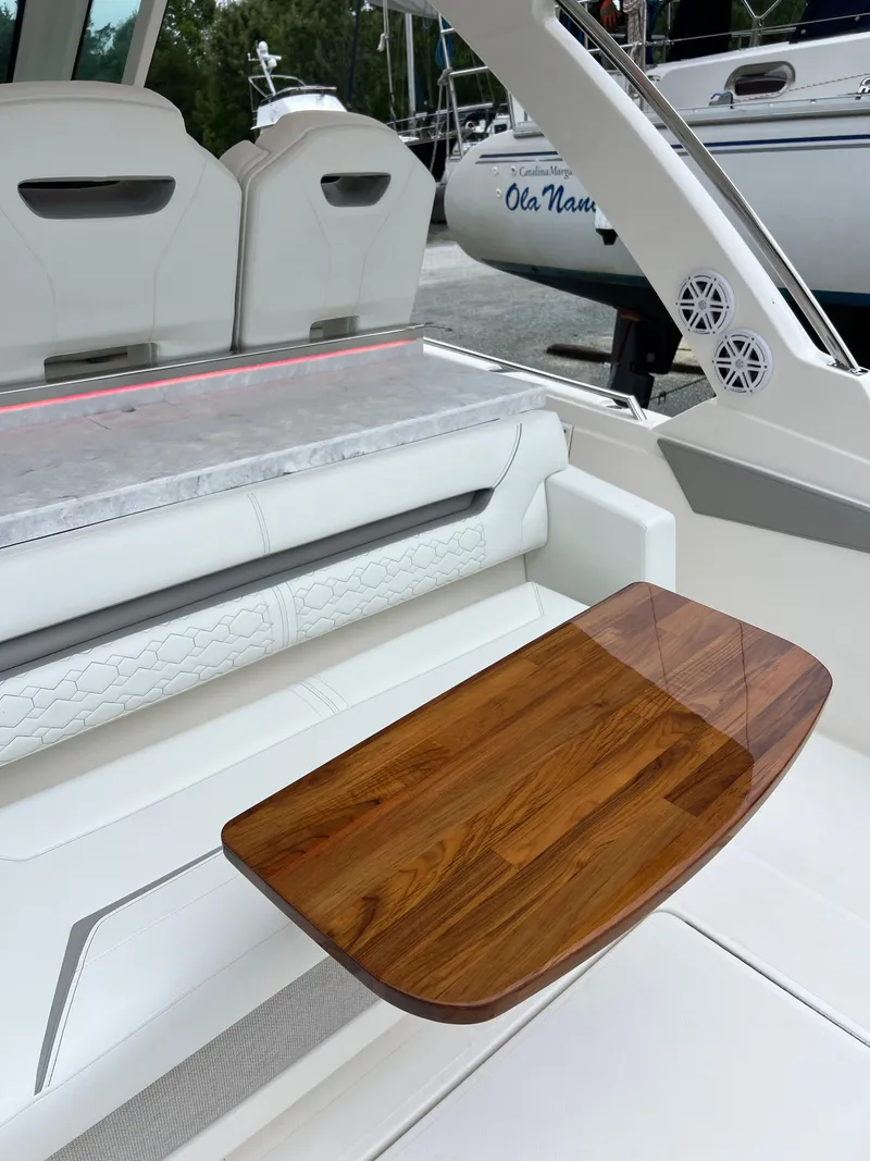 Slide: The Image of 2026 Tiara Yachts 34 LS interior with elegant seating and wooden table. - 7