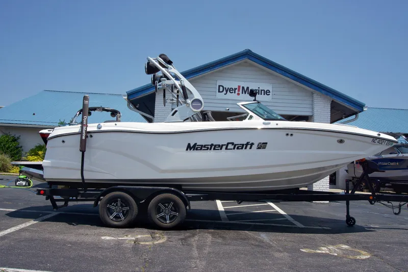 The Image of 2021 MasterCraft XT22 boat on trailer at Dyer Marine dealership. - 1