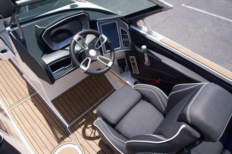Slide: The Image of 2021 MasterCraft XT22 boat interior with steering wheel and control panel. - 14
