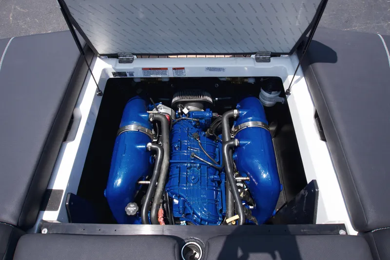 Slide: The Image of 2021 MasterCraft XT22 engine compartment with blue engine components. - 15