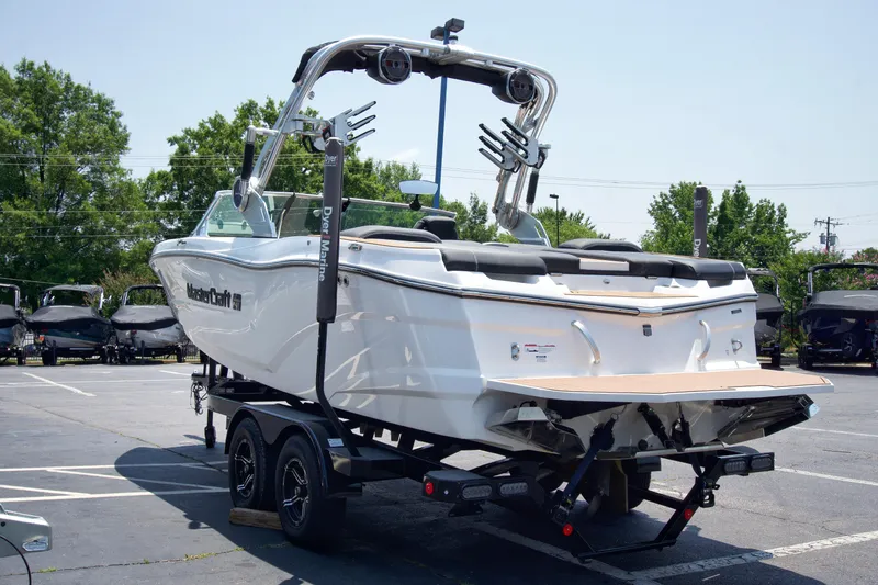 Slide: The Image of 2021 MasterCraft XT22 boat on trailer in parking lot, rear view. - 4