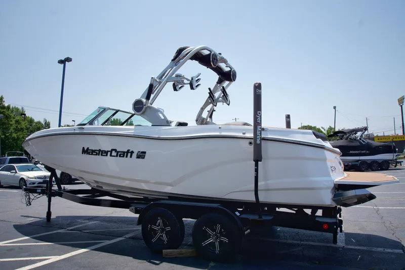Slide: The Image of 2021 MasterCraft XT22 boat on trailer in parking lot. - 5
