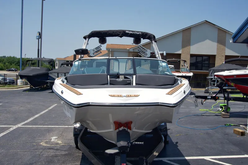 Slide: The Image of 2021 MasterCraft XT22 boat on trailer in parking lot, front view. - 7