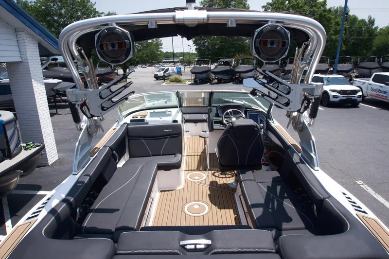 Slide: The Image of 2021 MasterCraft XT22 boat interior with sleek seating and advanced audio system. - 9