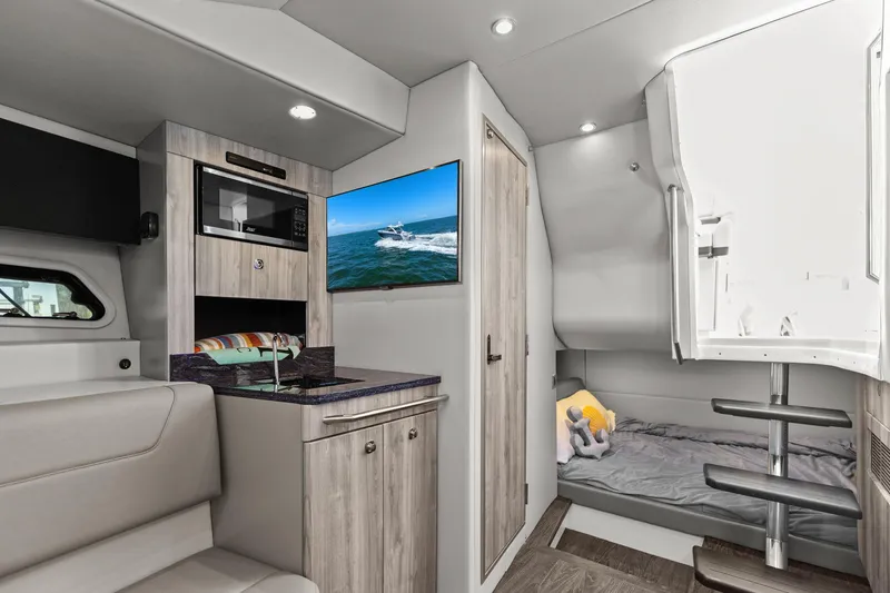 Slide: The Image of Interior of 2023 Formula 380 Super Sport Crossover OB, featuring modern amenities and cozy sleeping area. - 24