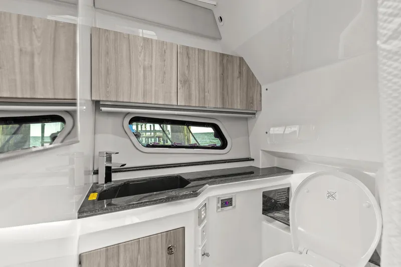 Slide: The Image of 2023 Formula 380 Super Sport Crossover OB interior bathroom with modern sink and toilet. - 29