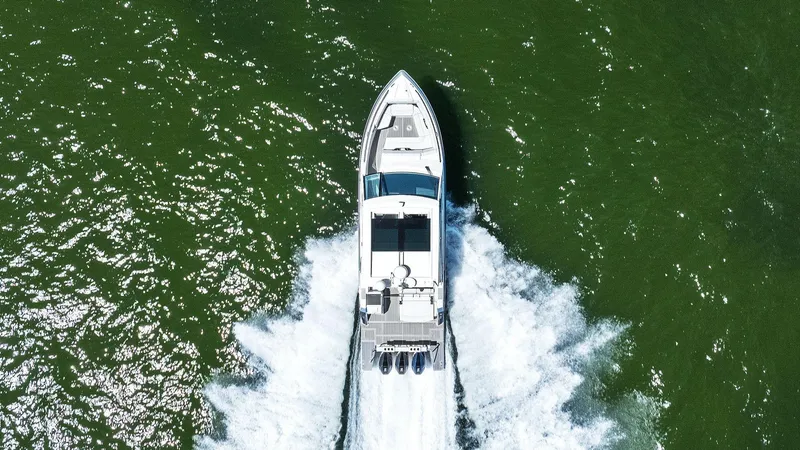 Slide: The Image of Aerial view of 2023 Formula 380 Super Sport Crossover OB cruising on green water. - 39