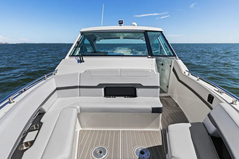 Slide: The Image of 2023 Formula 380 Super Sport Crossover OB cruising on open water, showcasing spacious seating. - 5